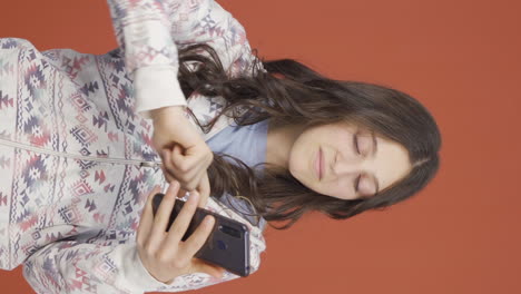 Vertical-video-of-The-young-woman-who-likes-the-new-app.-Phone-app.